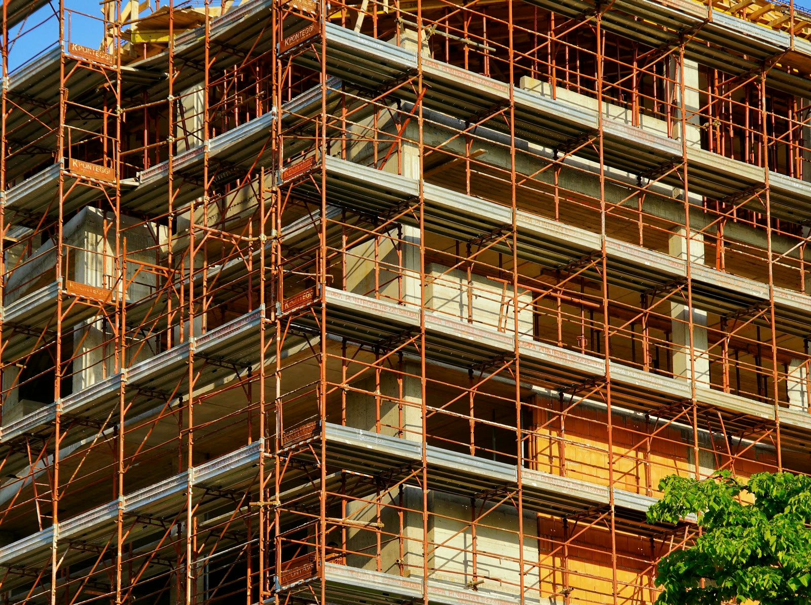 Building facade under scaffold during rectification works, as documented